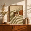 Bear reading canvas print displayed on a warm wood cabinet with dried flowers