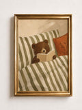 Close view of sleepy storybook bear tucked under sage and cream stripes