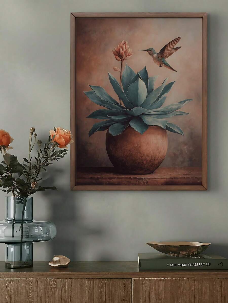 Framed agave and hummingbird print displayed above a console with flowers