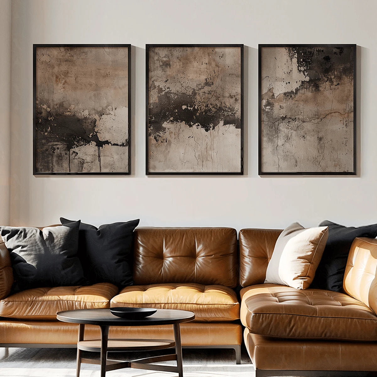 Wabi-sabi abstract canvas trio above a brown leather sofa
