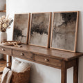 Framed wabi-sabi canvas poster set above a wood console with woven decor