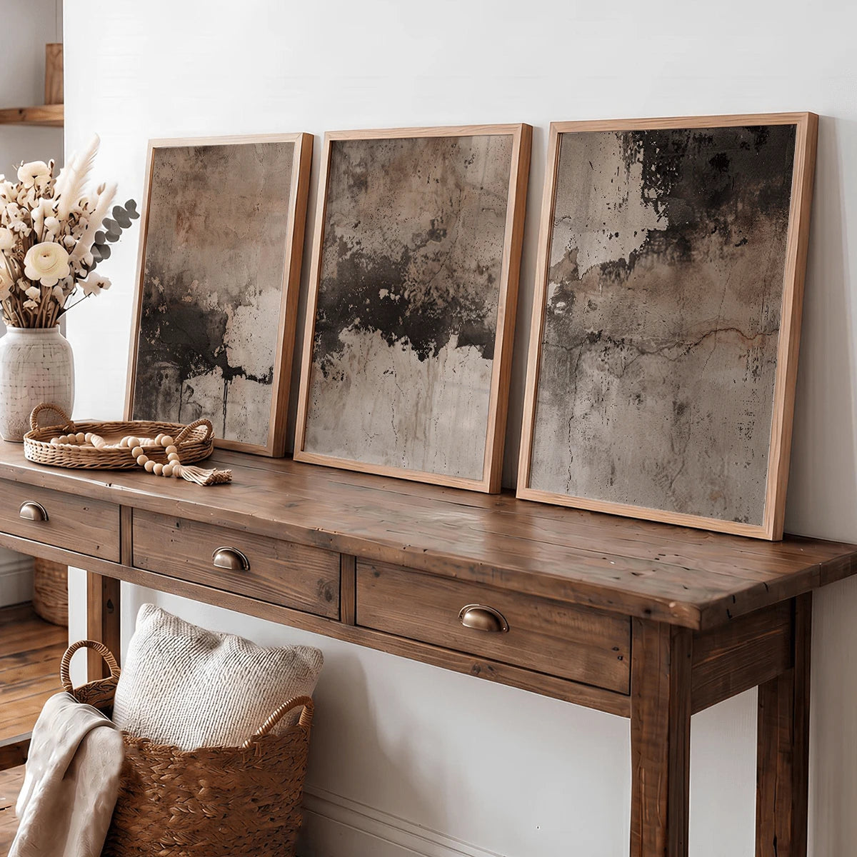 Framed wabi-sabi canvas poster set above a wood console with woven decor