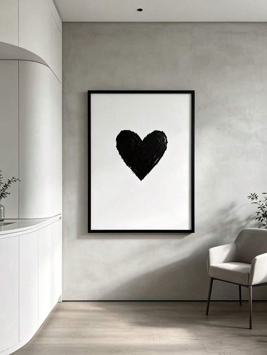 Black heart poster shown on a pale wall beside a modern lounge chair