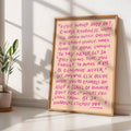 Framed quote poster leaning beside potted plant in a sunlit room