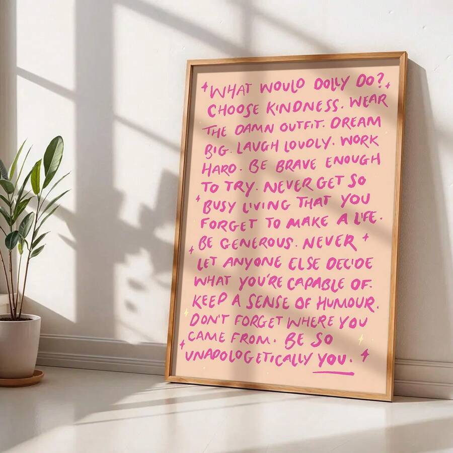 Framed quote poster leaning beside potted plant in a sunlit room