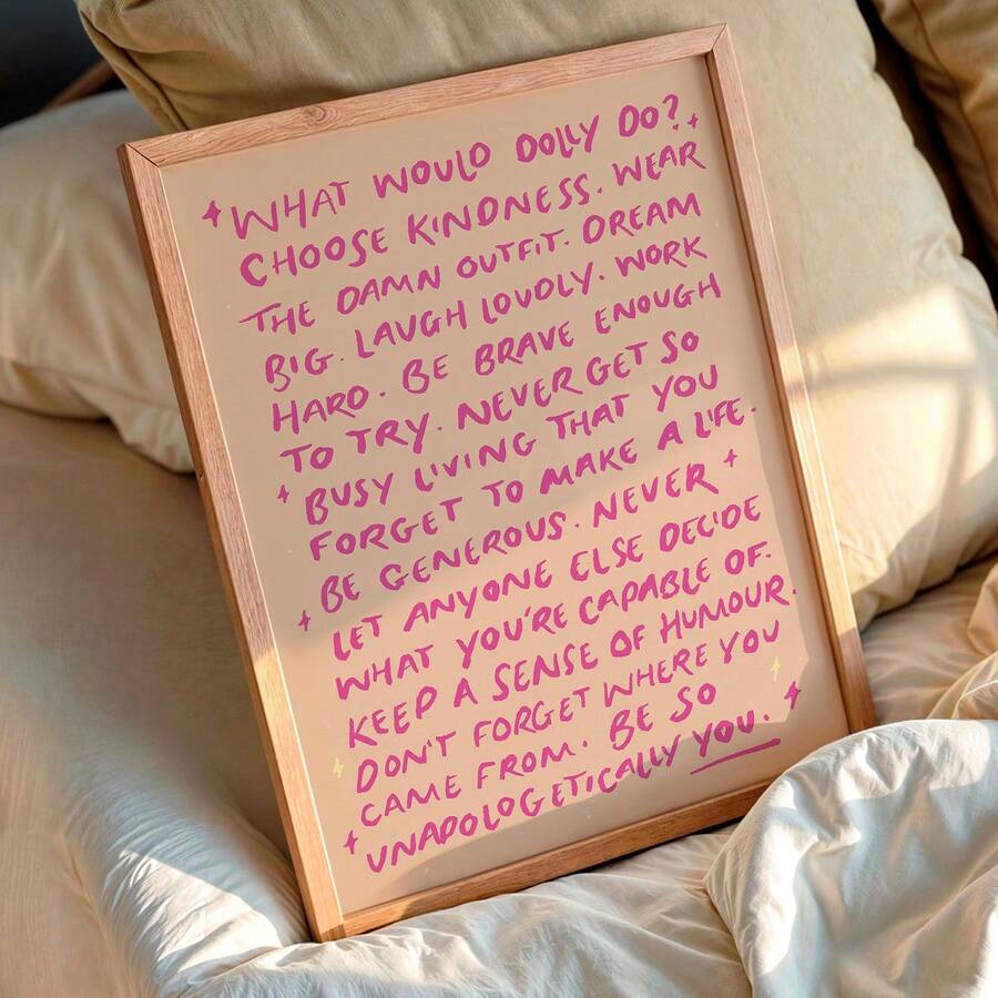 Close view of magenta brush lettering and yellow sparkles on framed quote