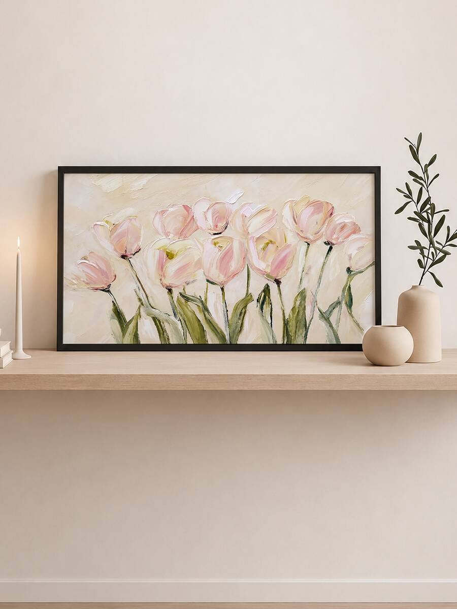 Wide framed canvas of loose pink tulips with green stems on a cream ground leaning by a rattan cabinet