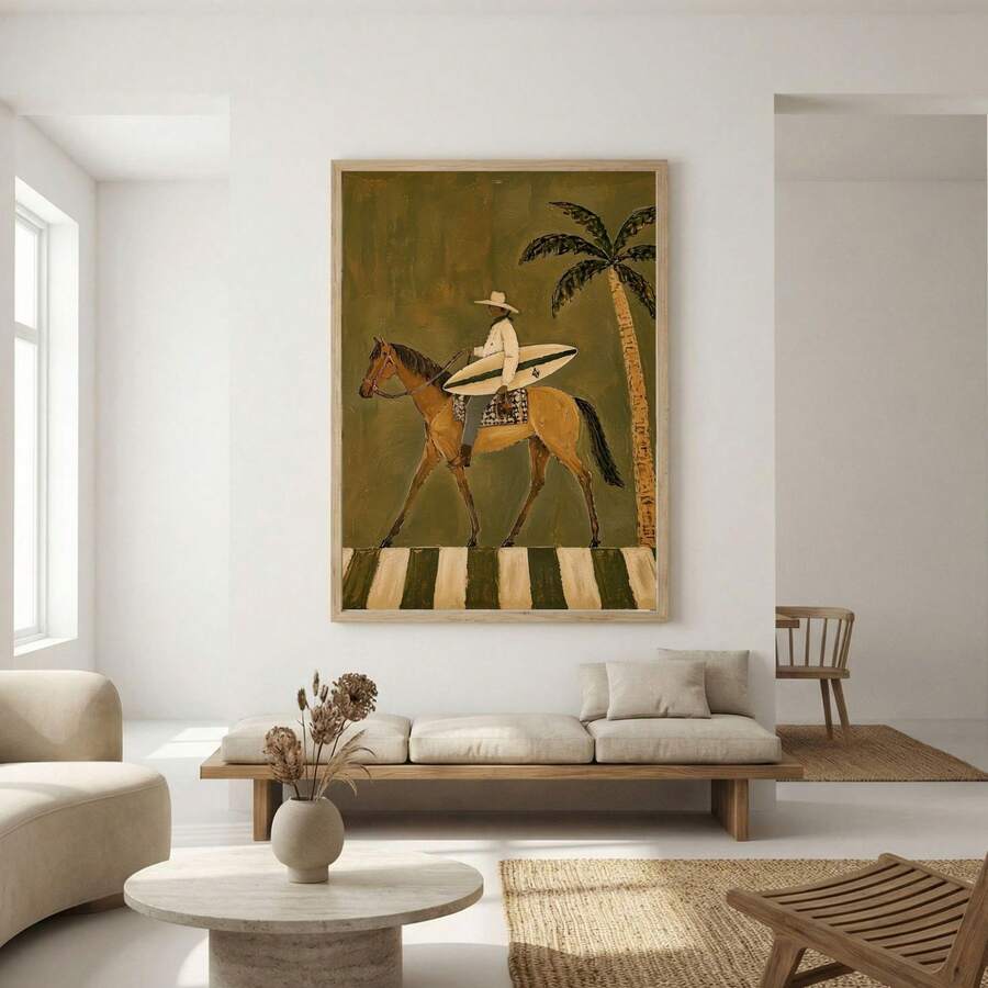 Framed coastal horse illustration above a sofa in a bright minimalist living room