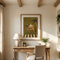 Framed horse and surfboard artwork centered above a home office desk in warm natural light