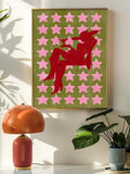 Red cowgirl and pink star print displayed above a record player