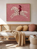 Framed cowgirl star artwork above a sofa with blush cushions