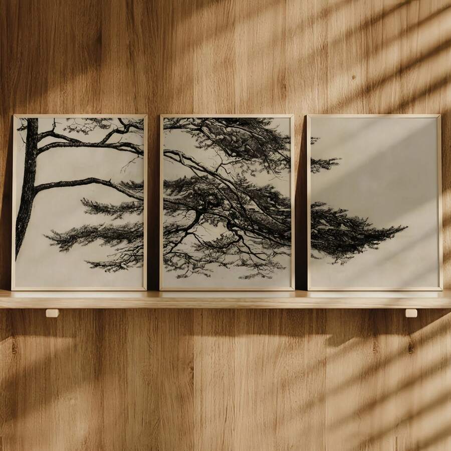 Three coordinating pine branch panels in natural frames on a warm wood wall
