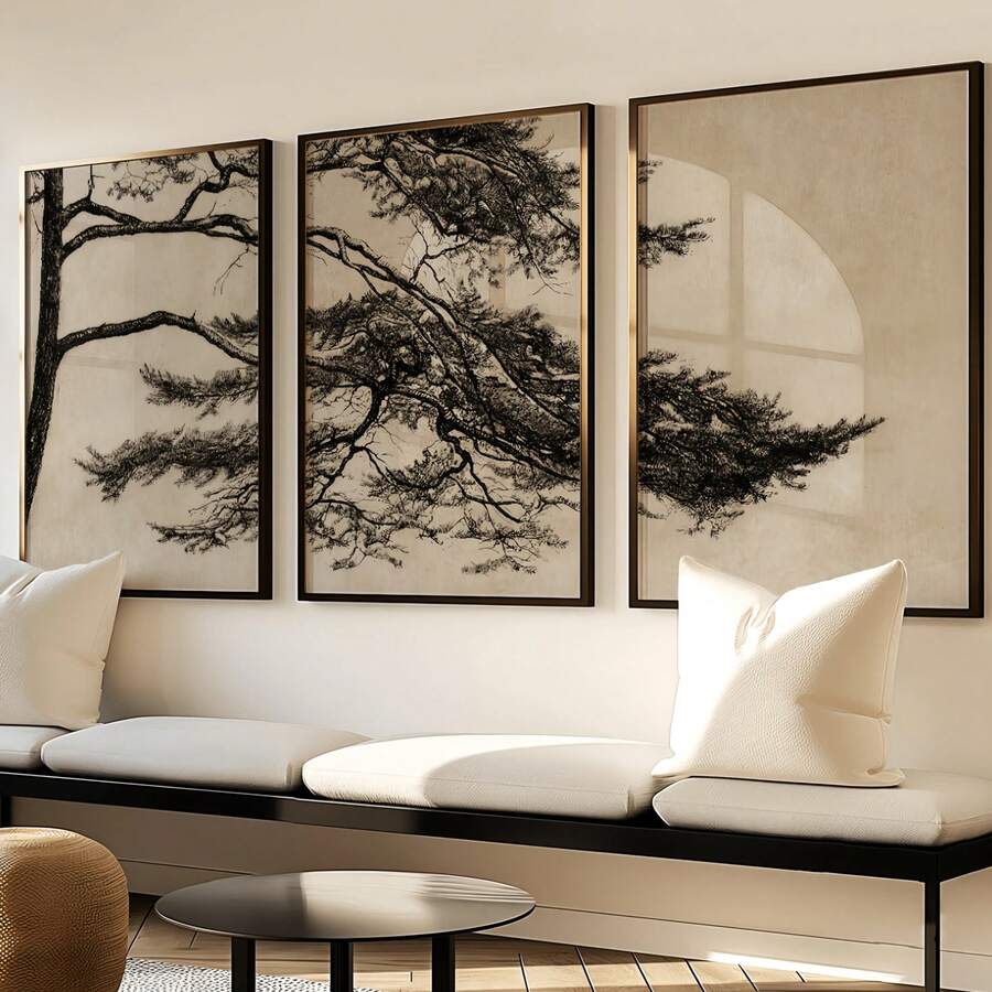 Botanical three-panel canvas in black frames above a light sofa in a neutral living room