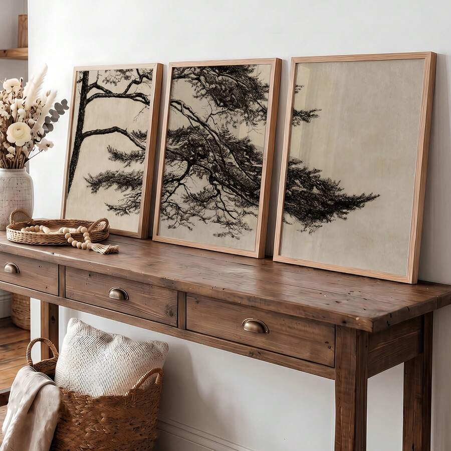 Pine branch triptych in natural wood frames displayed above a rustic console table