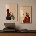 Pair of framed trumpet and cello player posters displayed above a turntable cabinet