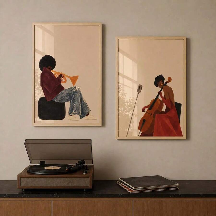 Pair of framed trumpet and cello player posters displayed above a turntable cabinet