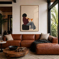 Framed trumpet player music poster above a brown leather sofa in a bright living room