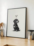 Black dachshund seated beneath a cocktail glass in a framed kitchen print