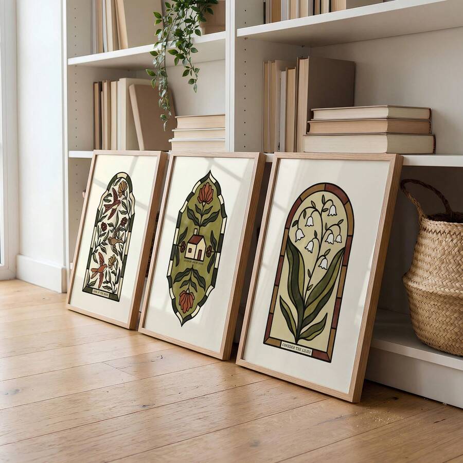 Close view of three arched vintage botanical canvas designs leaning beside shelves