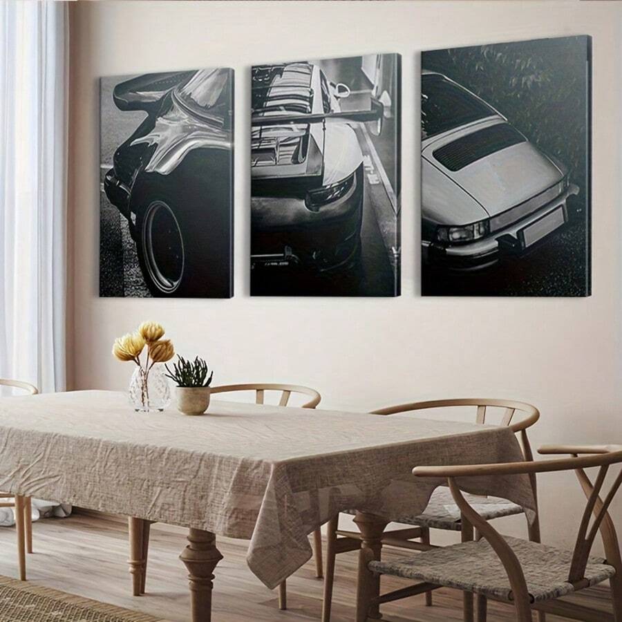 Black and white automotive canvas triptych above a modern dining table