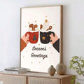 Wood-framed holiday canvas showing two festive cocoa mugs on a pale wall