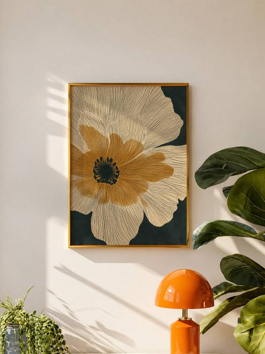 Framed botanical flower canvas on pale wall beside leafy plant and orange lamp