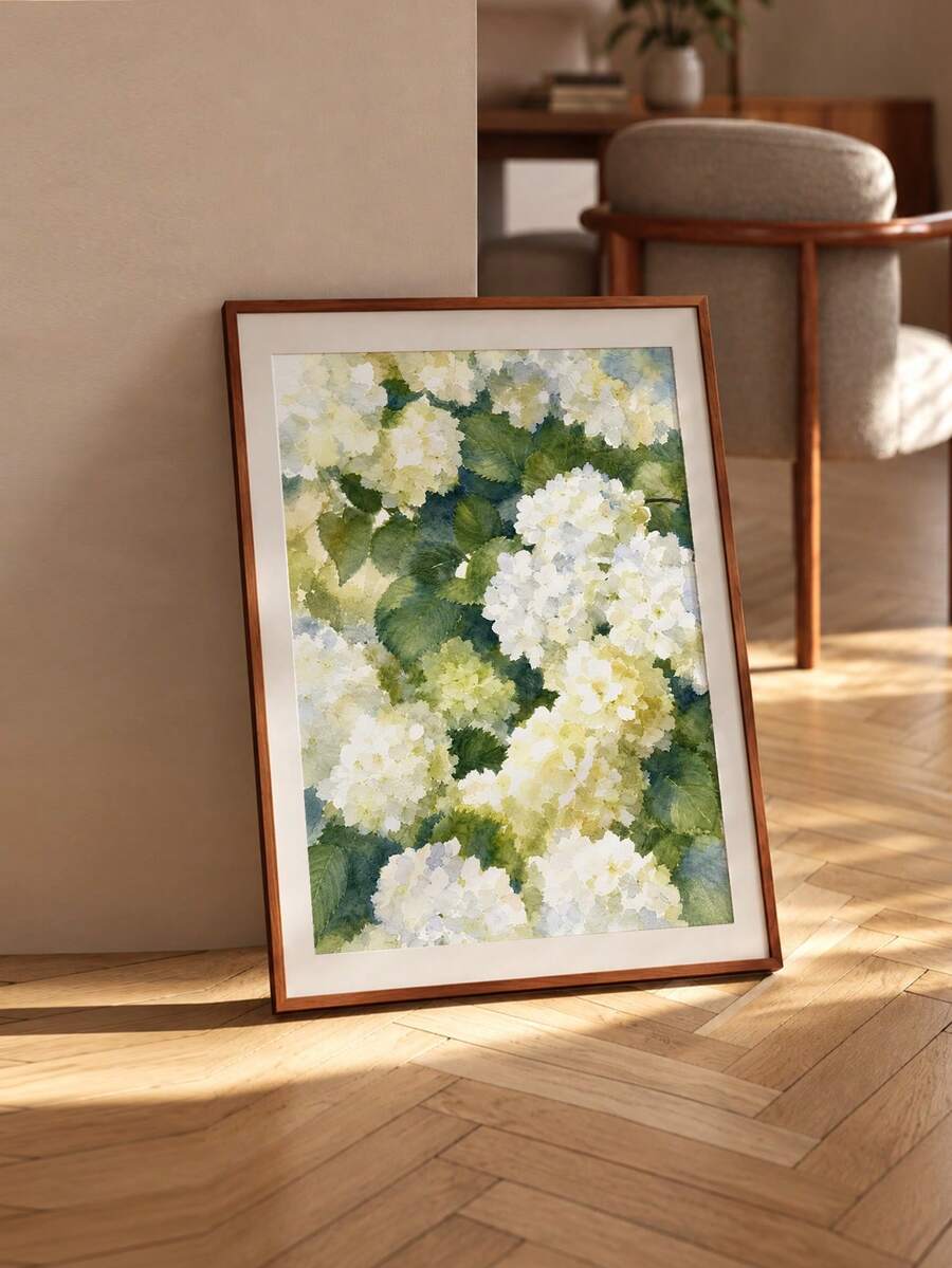 Watercolor hydrangea print leaning in a sunny living area with wood frame