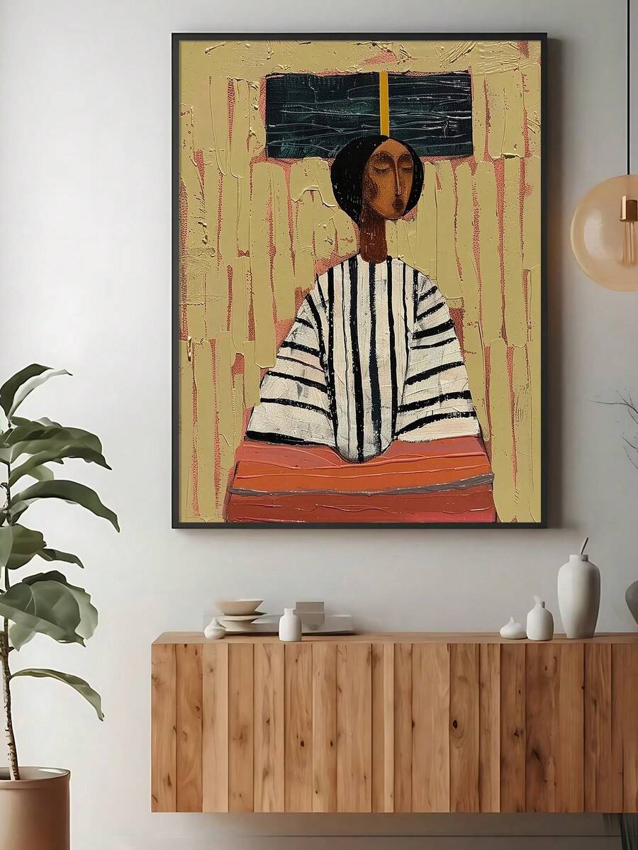 Abstract portrait canvas print in a black frame above a modern sideboard