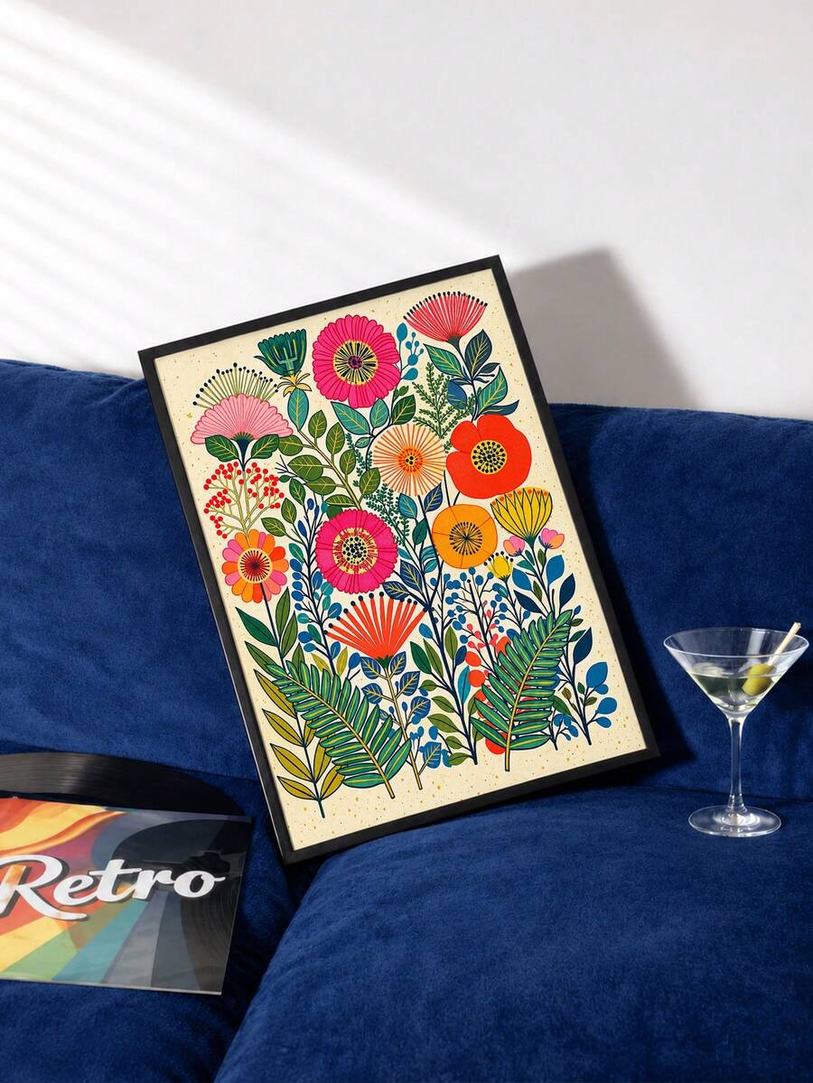 Bright botanical canvas leaning against a deep blue sofa