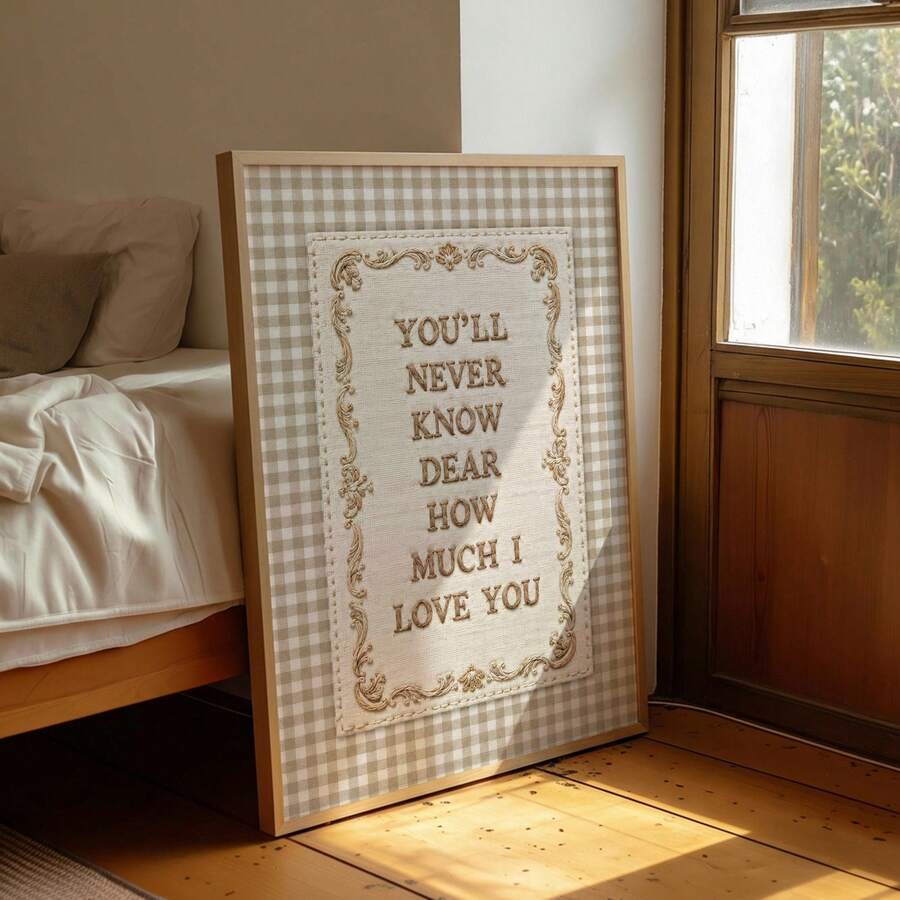 Beige gingham love quote poster framed beside a soft sofa and reading nook
