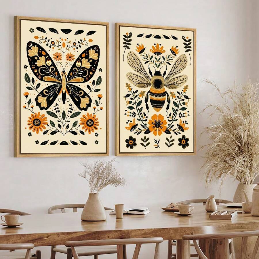 Framed monarch butterfly and bee folk art poster set above a modern sideboard