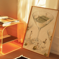 Tennis court inside a martini glass canvas leaning beside an orange-lit console and books