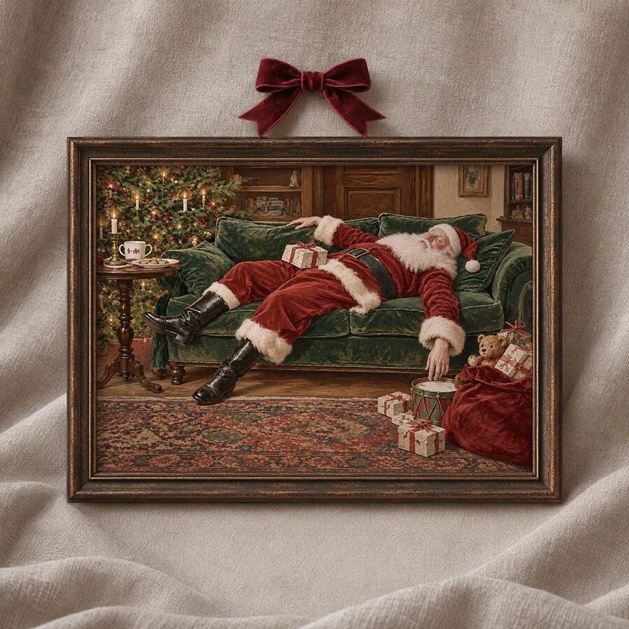 Close view of sleeping Santa artwork in a dark wood frame with a red bow