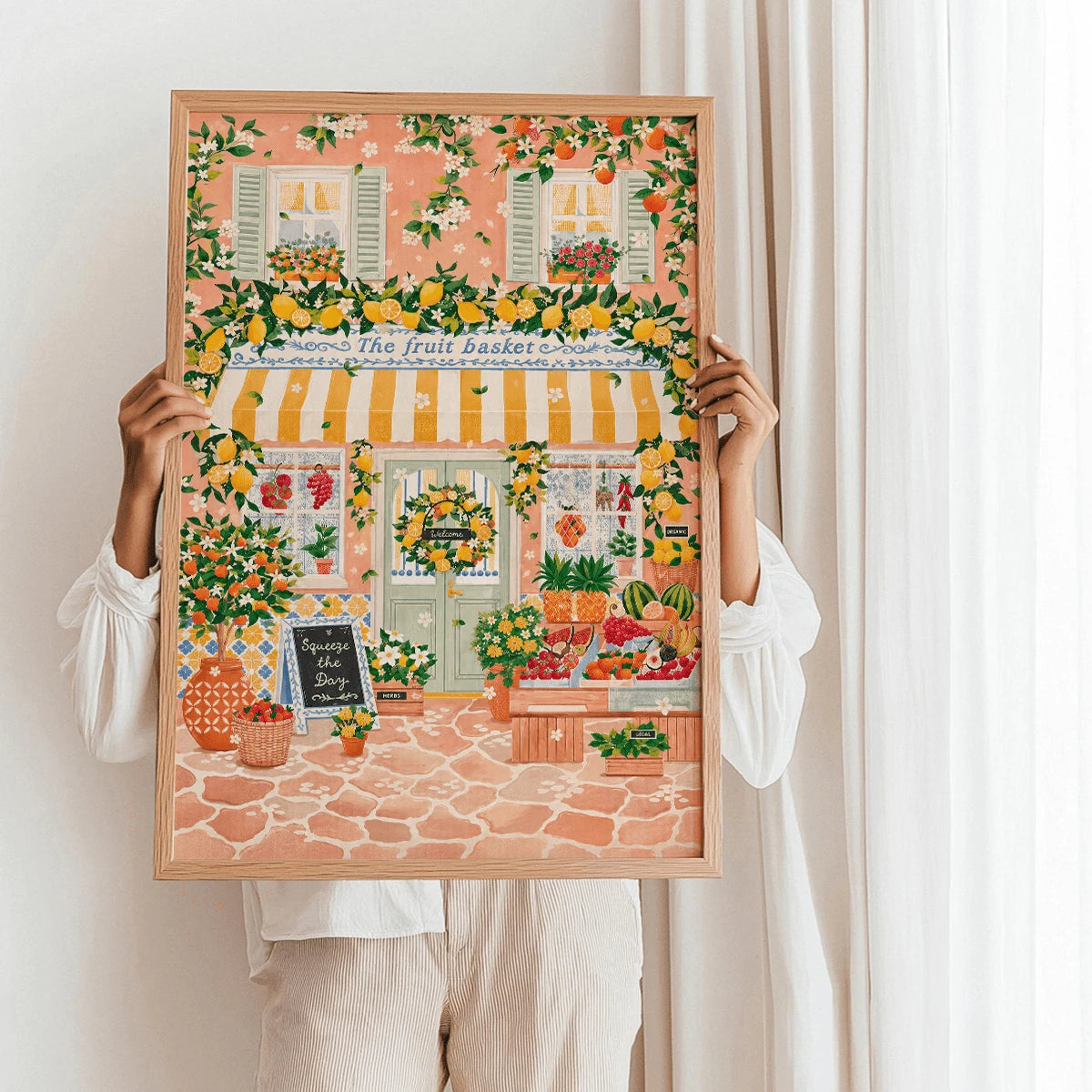 Mediterranean fruit basket artwork held in a light wood frame