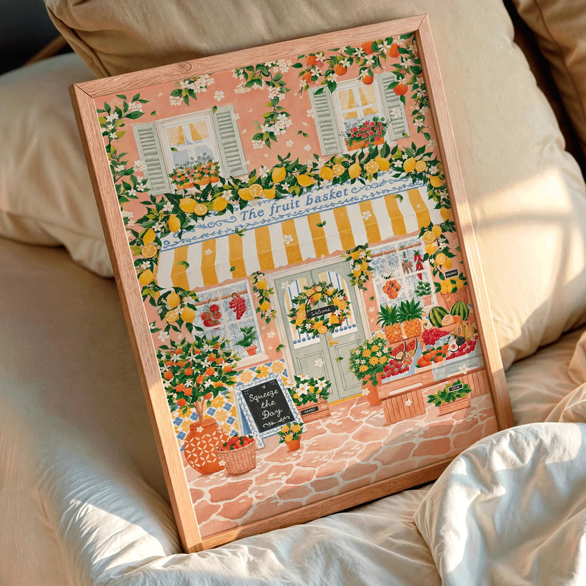 Lemon market canvas poster framed beside a sunlit bed