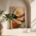 Wood-framed olive branch and golden sun poster displayed in an arched niche beside green foliage