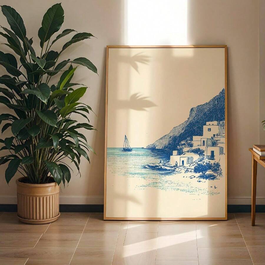 Blue seaside village canvas print displayed beside a leafy plant in a sunlit living room