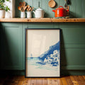 Greek island canvas print with white hillside homes and turquoise shore framed in green kitchen