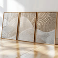 Close view of beige and cream abstract triptych canvases in slim wood frames