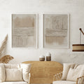 Two cream and beige ribbed abstract canvases above pale sofa and wood sideboard