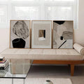 Three piece neutral abstract wall art set with beige black shapes and wood frames