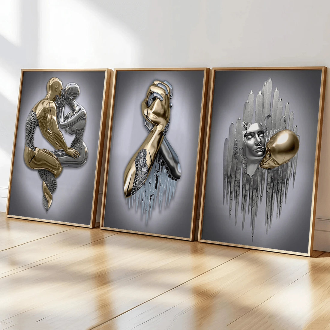 Three gold-framed metallic-effect figurative prints showing intertwined figures, clasped hands and touching faces