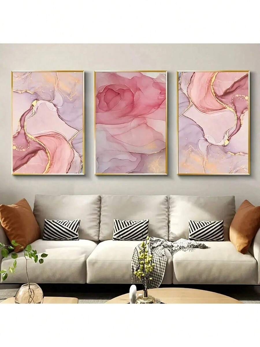 Three pink marble abstract canvas prints with gold accents above beige sofa