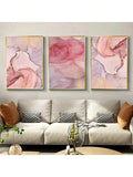 Three pink marble abstract canvas prints with gold accents above beige sofa
