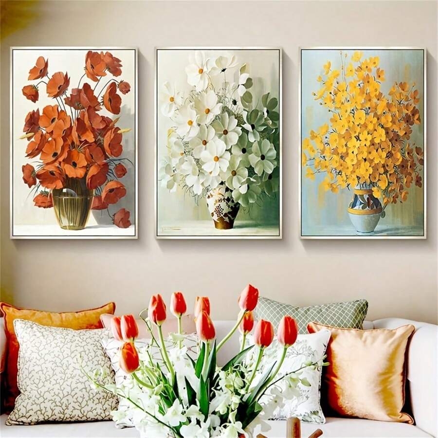 Three framed vase flower prints above a bright living room sofa