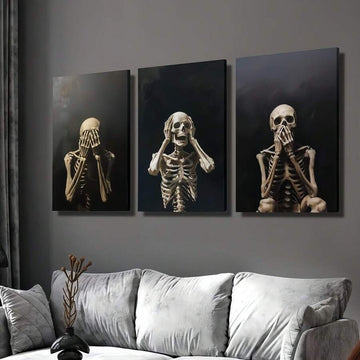 Three gothic skeleton prints in expressive poses arranged above a light sofa