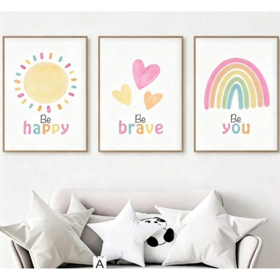 Three-piece kids wall art above sofa with Be happy sun, Be brave hearts and Be you pastel rainbow