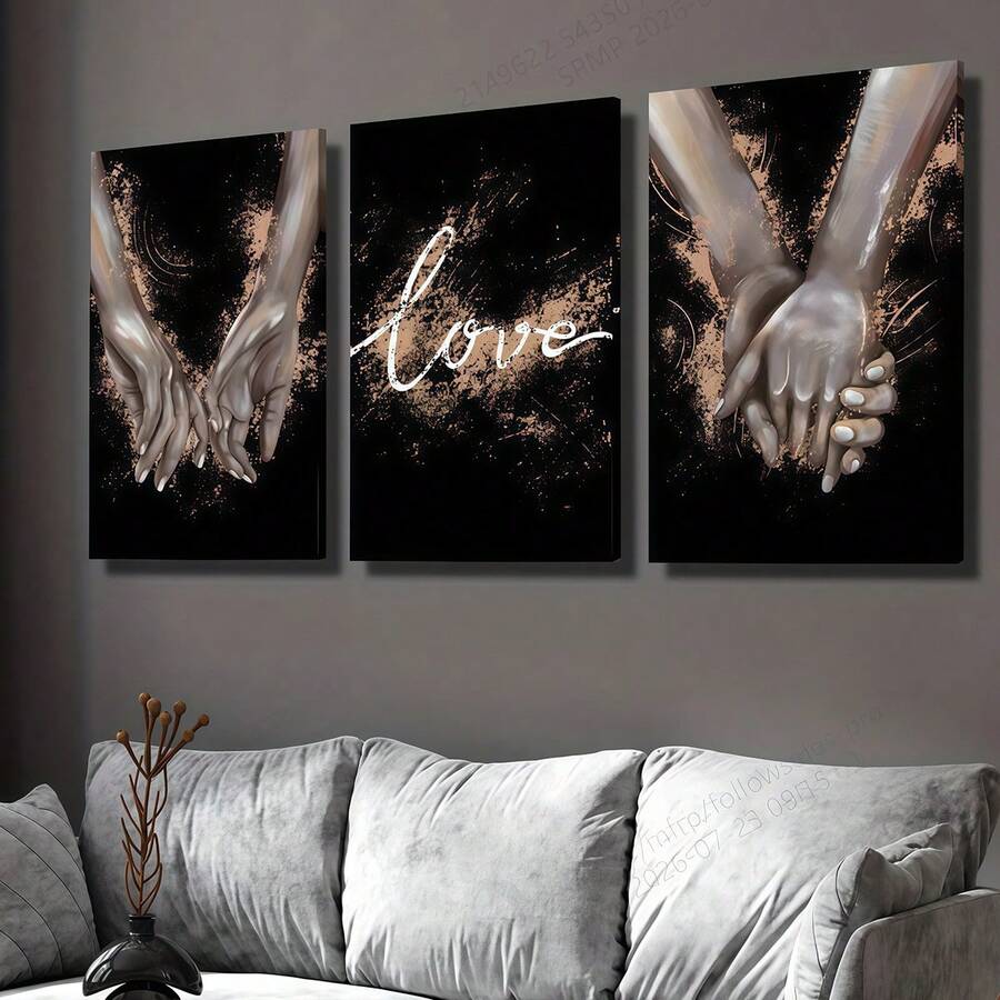 Three black and gold love prints with reaching hands and script above a sofa