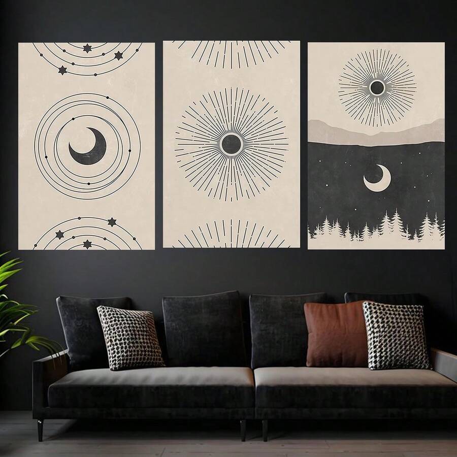 Three celestial prints with orbital crescent, radiating sunbursts, and forest night scene above a dark sofa