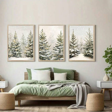 Three framed snowy pine landscape panels arranged above a sage green bed